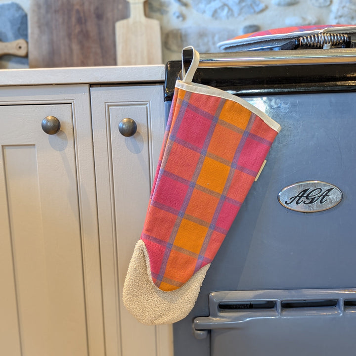 Oven Glove Gauntlet hanging off an Aga, pink orange blue plaid tyle check pattern