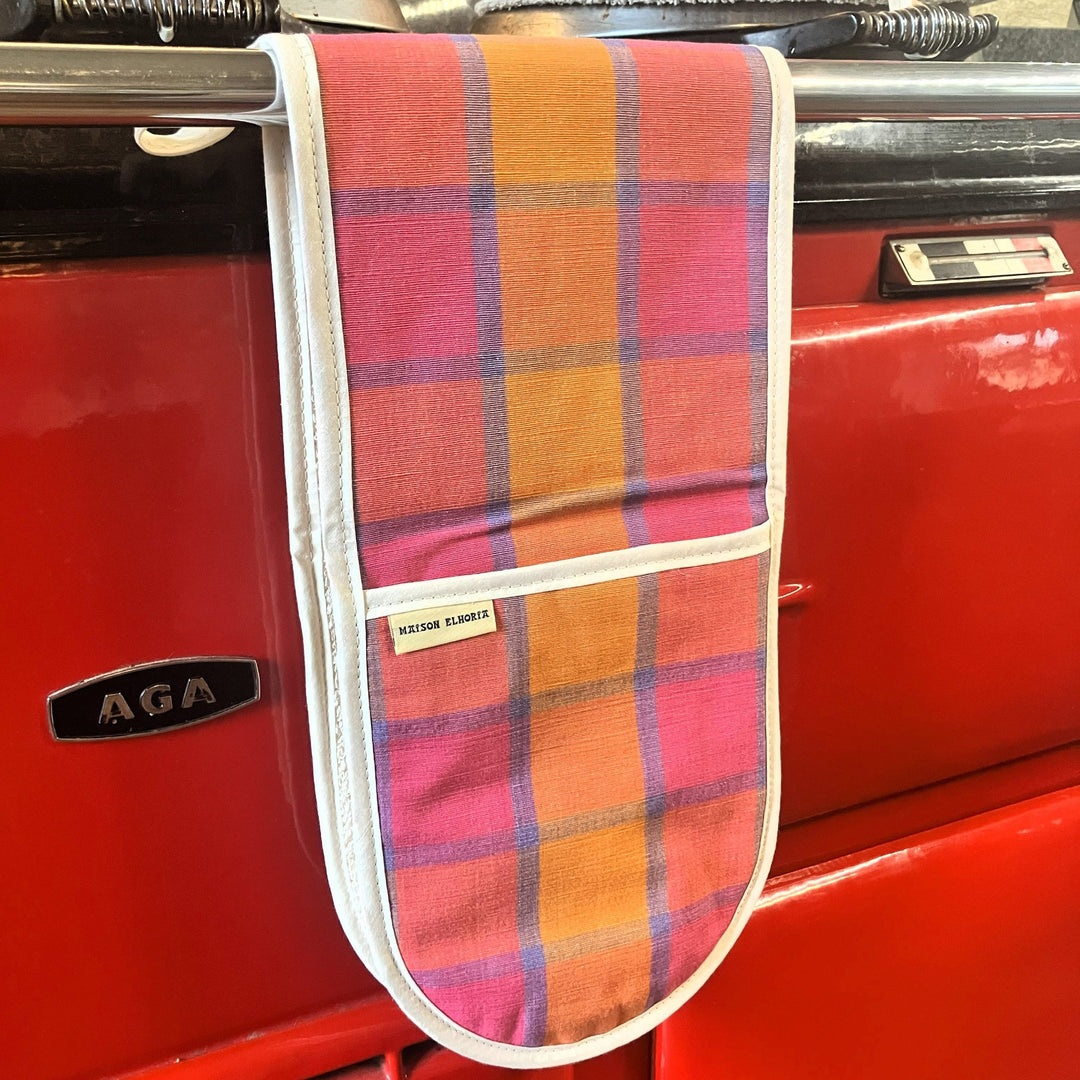 Plaid oven mitt on a red AGA stove