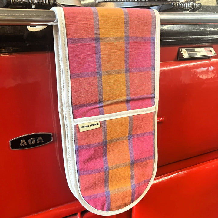 Plaid oven mitt on a red AGA stove