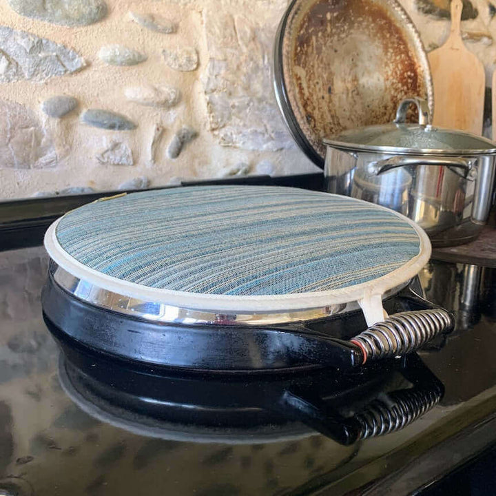 One Chef s pad blue on top of an Aga lid hob cover