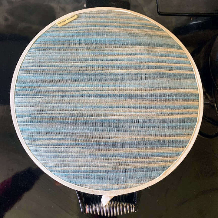 Aga hob lid cover with blue stripes close up , dark background 