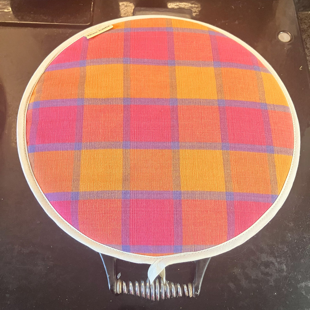Colourful checked Aga pad on an Aga lid