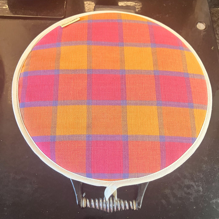 Colourful checked Aga pad on an Aga lid