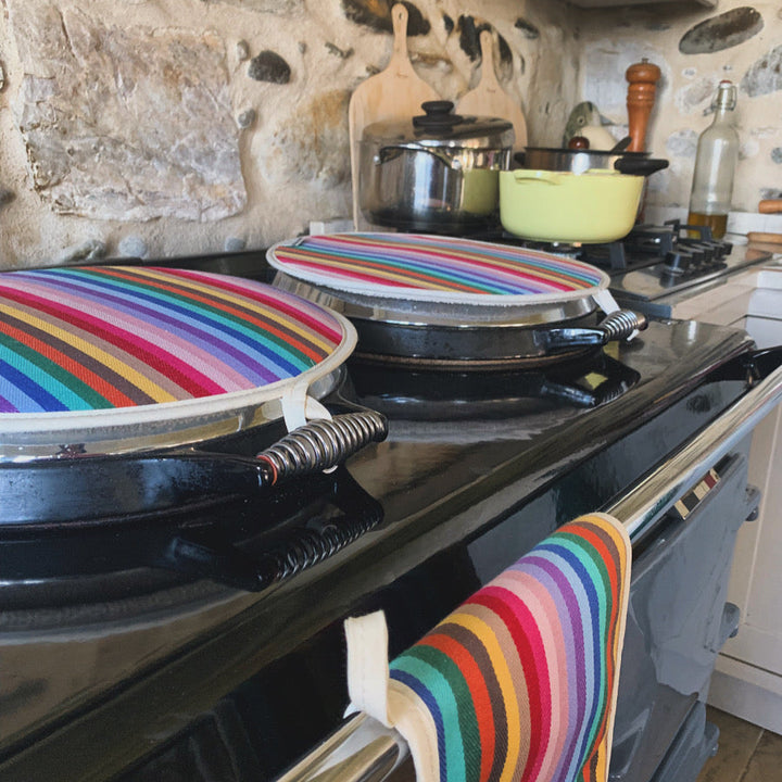 Kitchen \Aga cooker with a pair of rainbow Aga hob covers and a matching double oven glove hanging