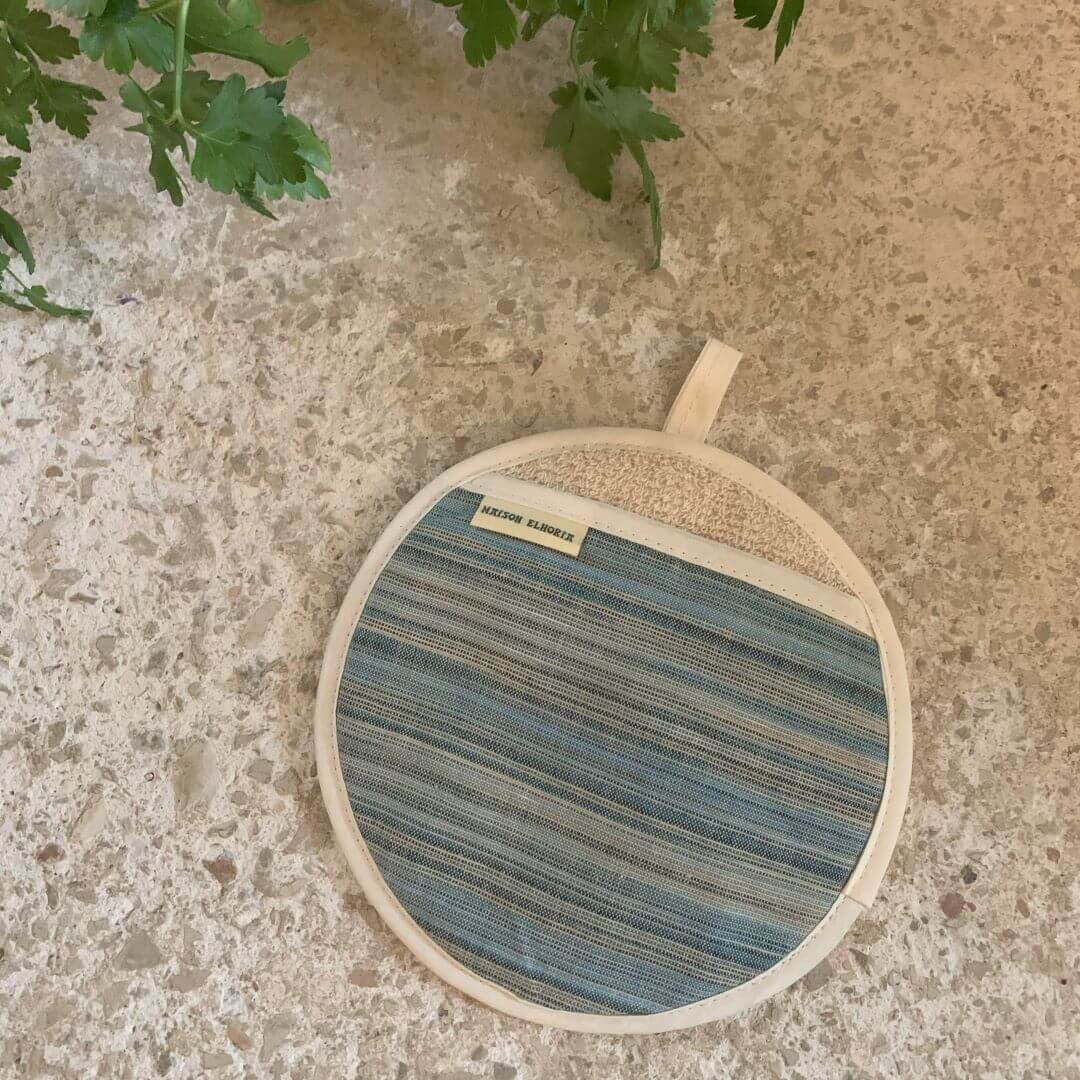 Pot grab blue striped and round flat on off white surface