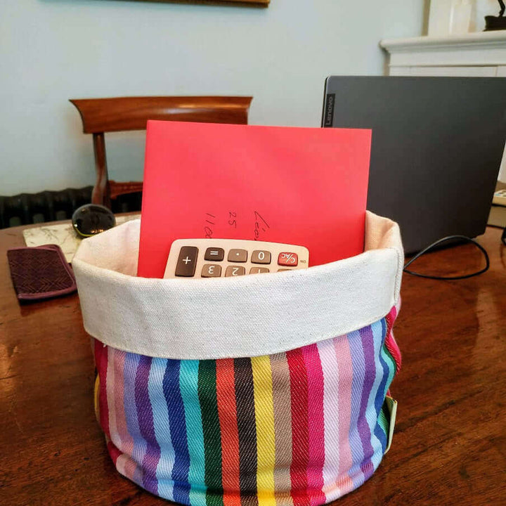 rainbow cotton storage pot bag on a table set holding letters