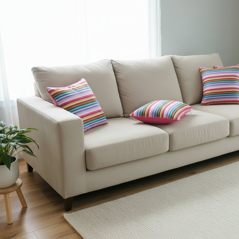 Rainbow cushion on a beige sofa close up