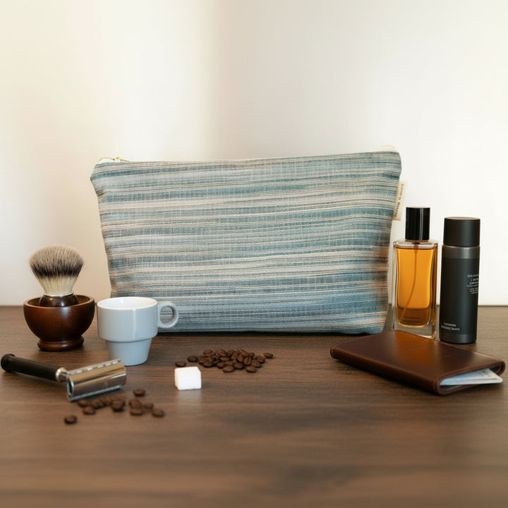 Blue striped men wash bag large size on a kitchen worktop with a coffee cup shaving kit and men toiletries