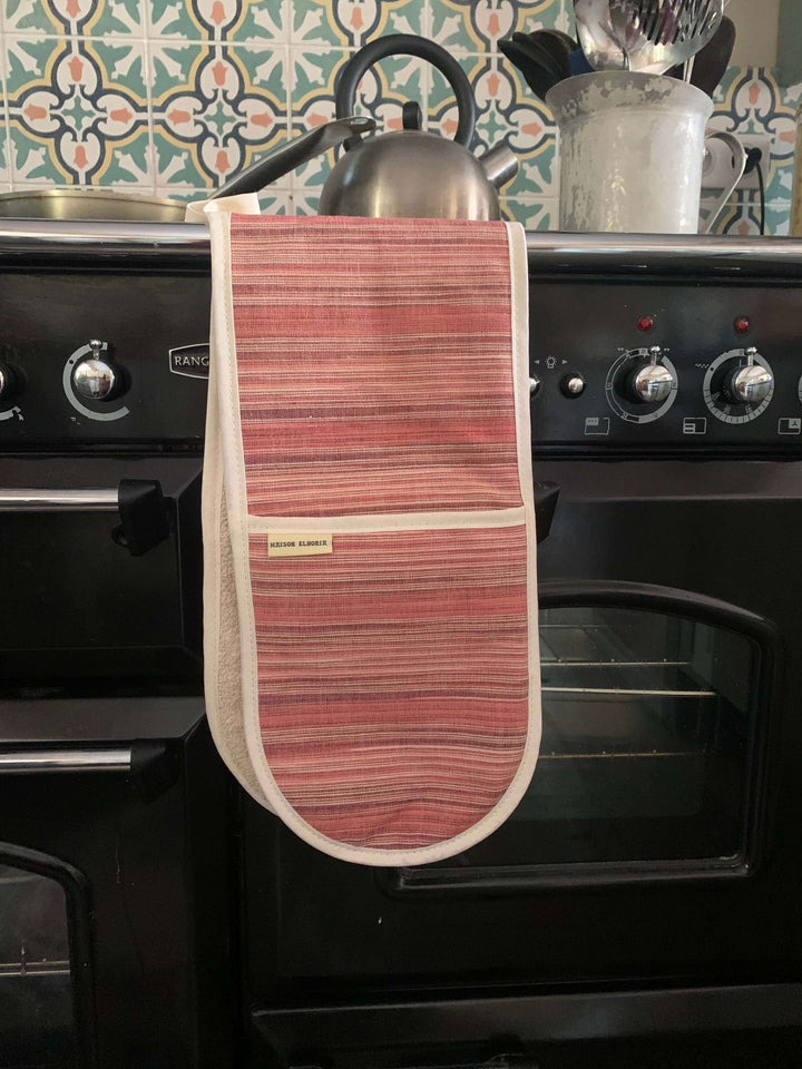 Red oven mitts double handed, hanging off a blancs cooker handle bar