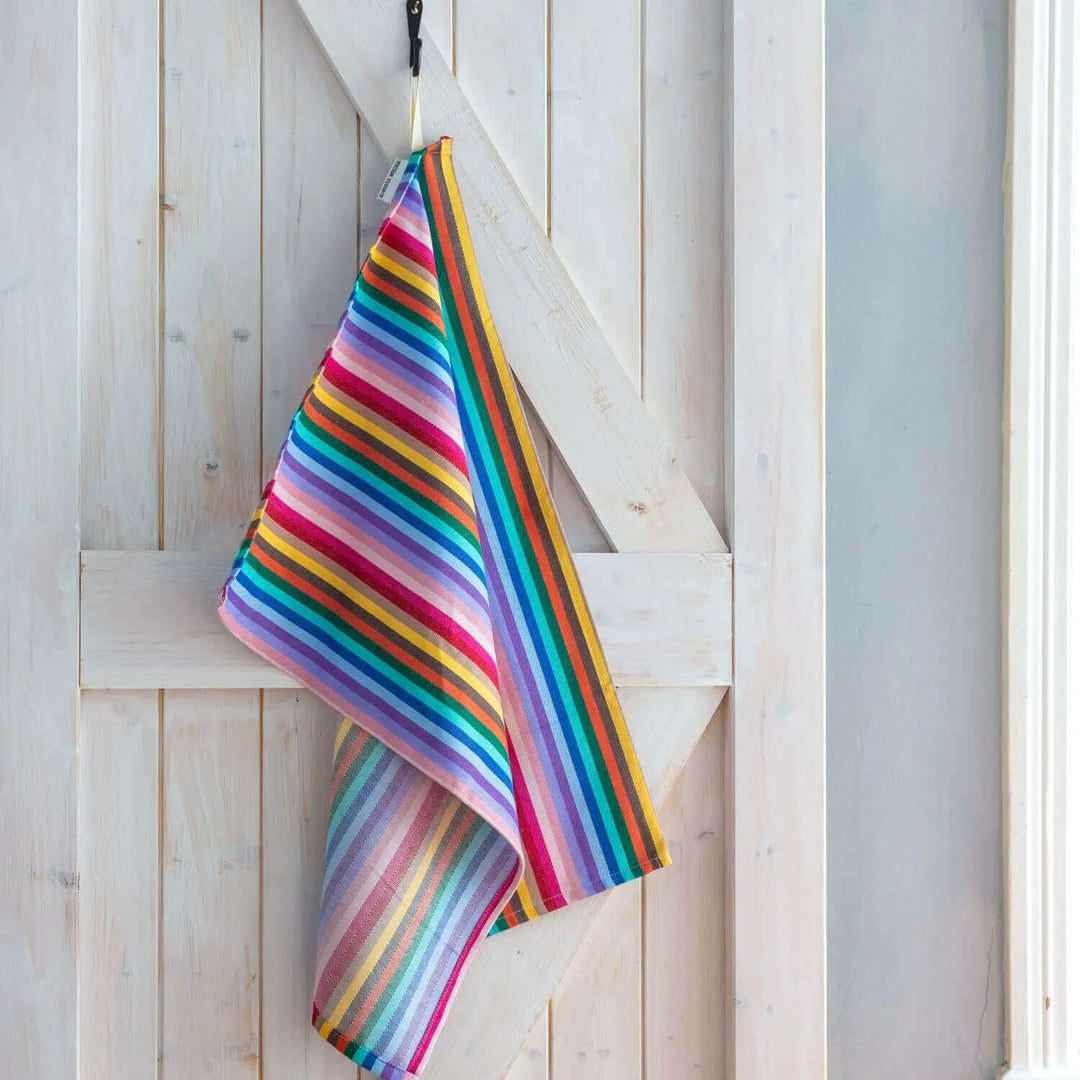 Tea Towel Rainbow  hanging off a wooden door painted in white Maison Elhoria