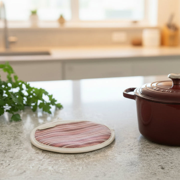 Pot grab red striped and round flat on off white surface with a le creuset pot and parsley