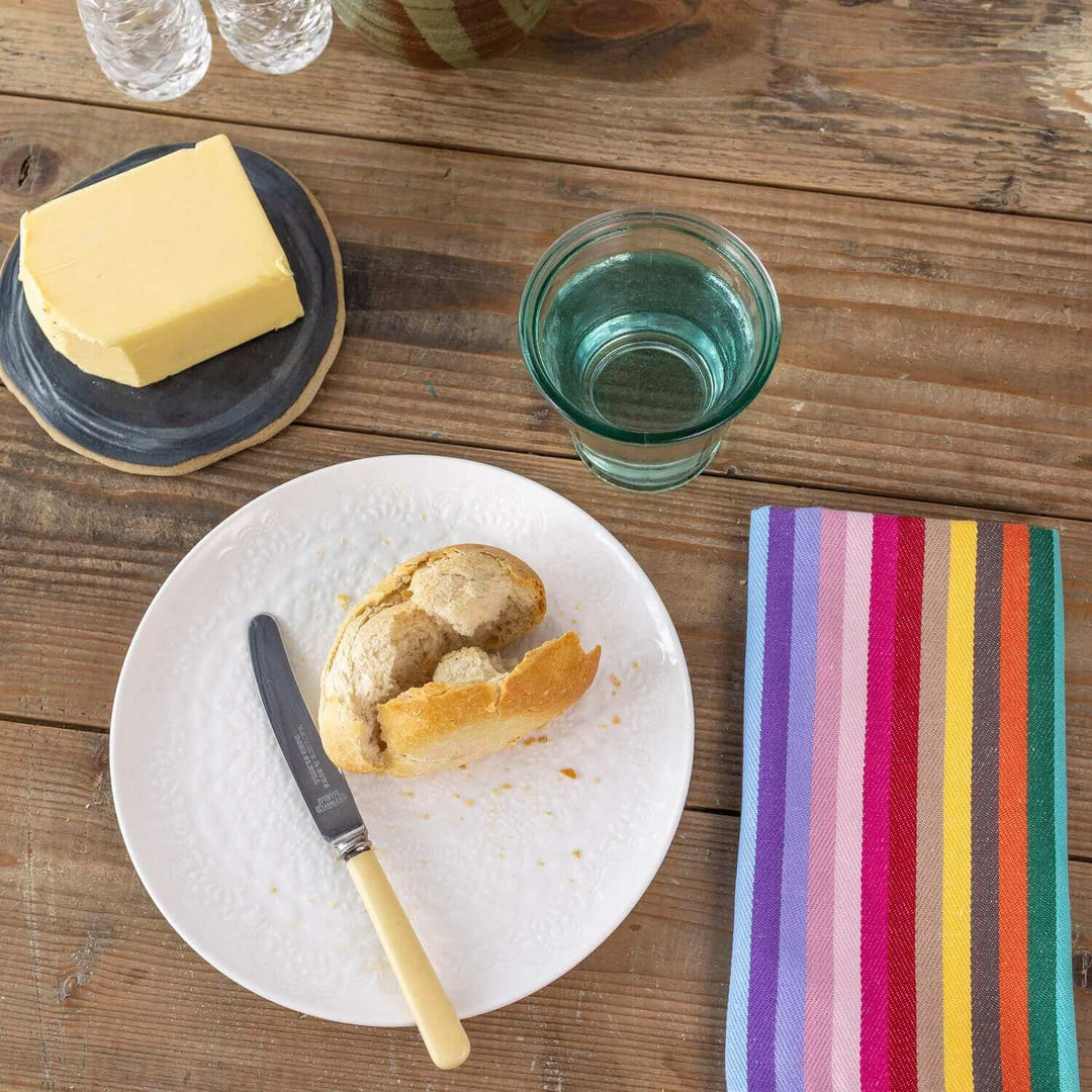 Rainbow organic Napkin bread and butter on wooden table